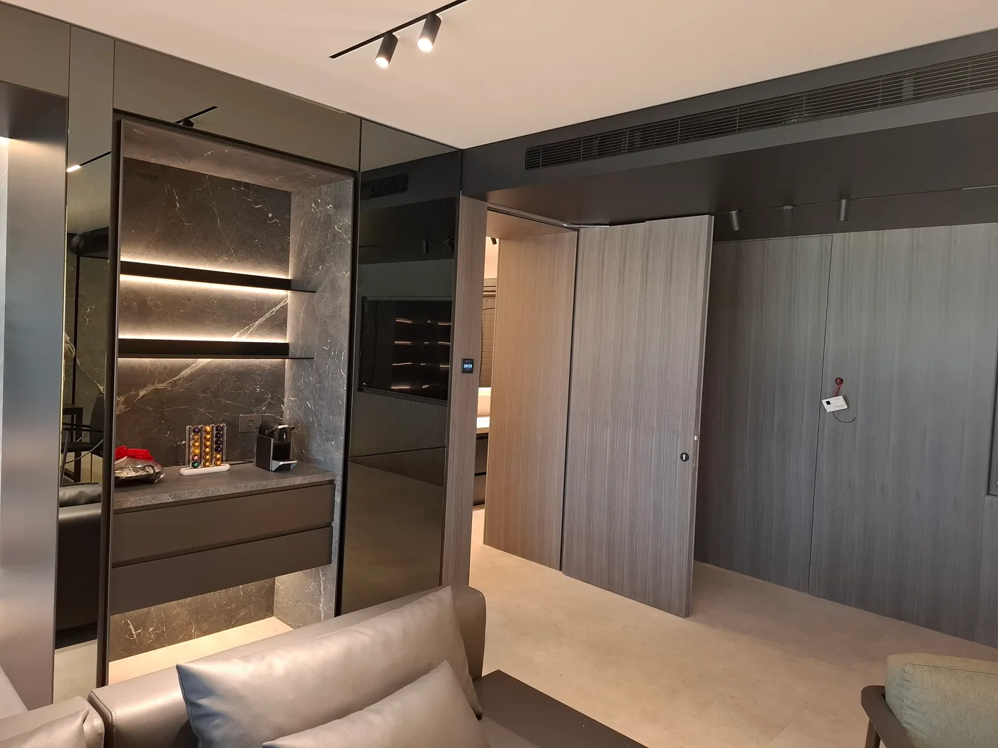 Mirror-clad corridor and ceramic coffee nook