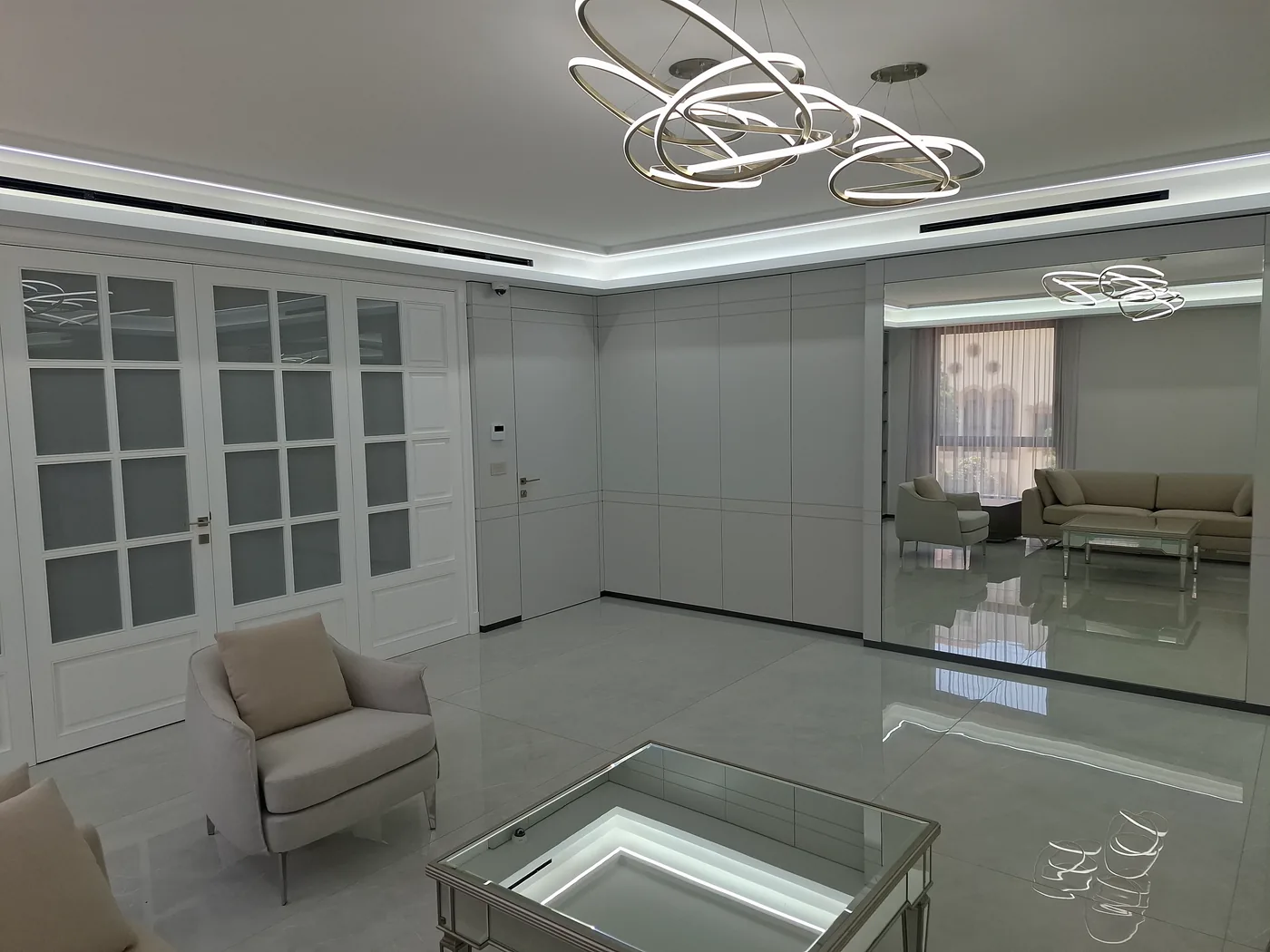 Reception — glazed doors and mirror-clad wall