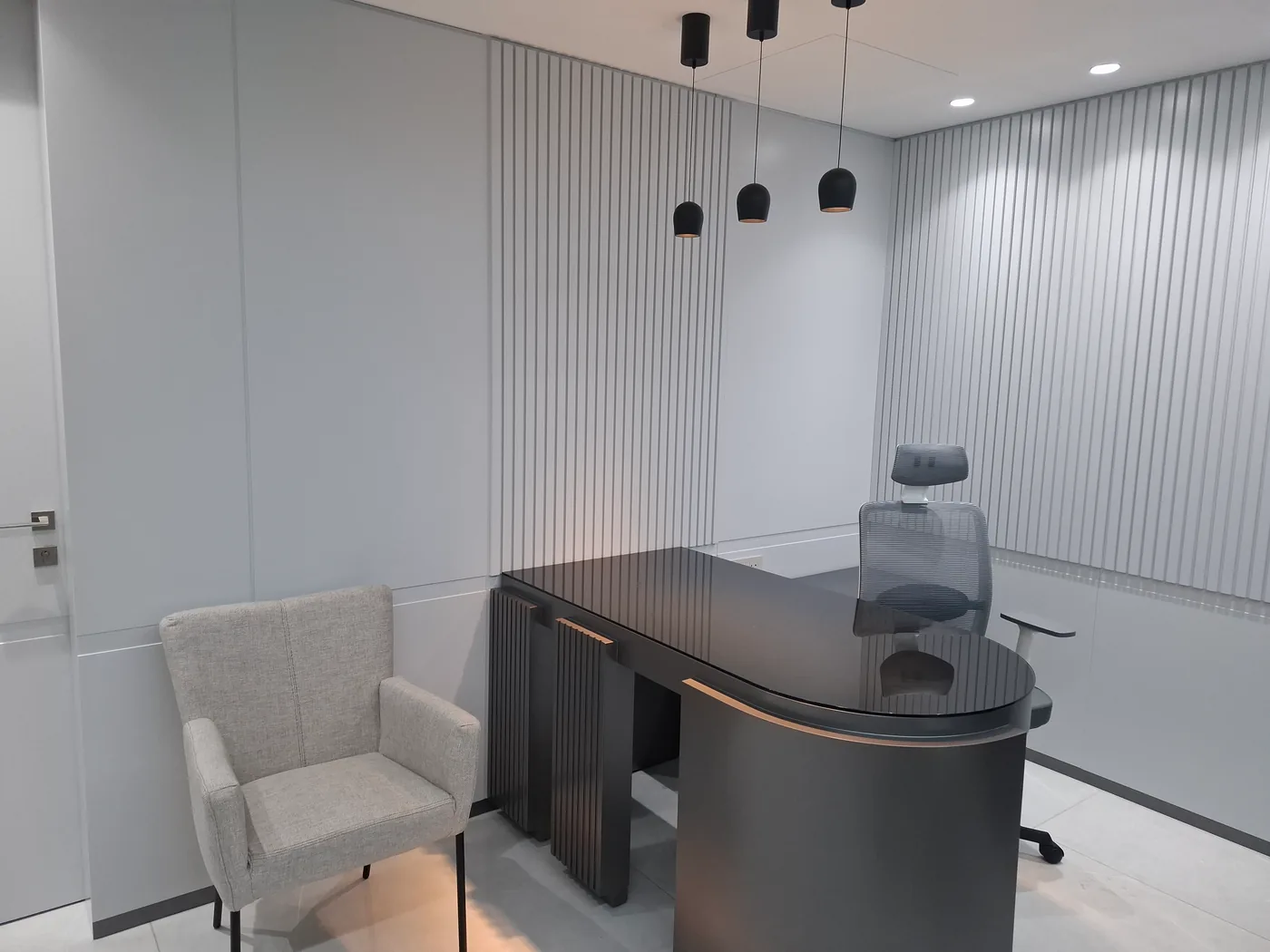 Private office — fluted panelling and desk