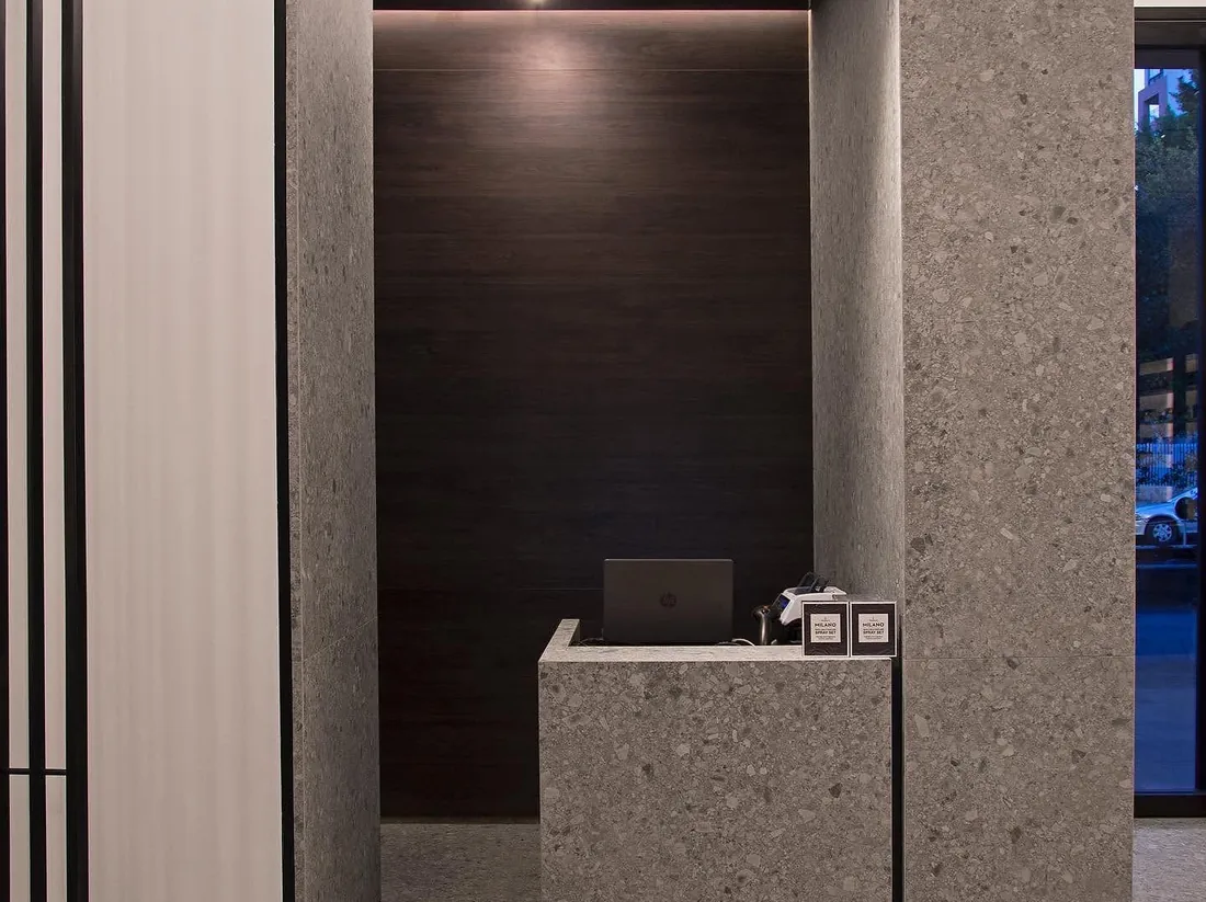 Reception nook — terrazzo and dark timber